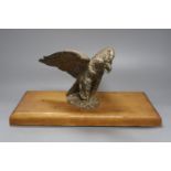 A plated Prussian eagle finial for a Prussian Guard’s helmet, later wood plinth, W36cm