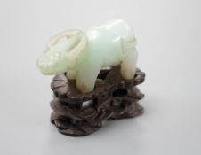 A small Chinese jade figure of a buffalo, late 19th/early 20th century, 3.8cm long, wood stand