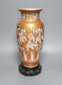 A tall Japanese Kutani porcelain vase, decorated with Rakan, 30cm, wood stand