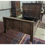 A 17th century style panelled oak bedstead, width 143cm, length 204cm, height 140cm