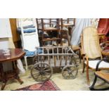 A Victorian oak and beech framed child's cart, with iron bound spoked wheels, length 104cm, depth