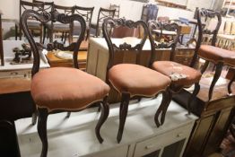 A set of six Victorian carved rosewood balloon back dining chairs