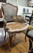 A 19th century French carved and caned walnut salon chair, width 52cm, depth 46cm, height 87cm