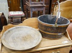 A copper bound staved oak log basket, width 45cm, depth 36cm, together with a circular turned