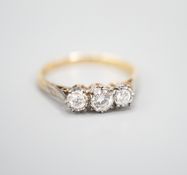 A modern 18ct gold and three stone diamond ring, size Q/R, gross weight 3 grams.