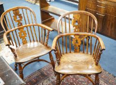 A pair of 19th century Yorkshire area yew and elm Windsor elbow chairs with crinoline stretchers,