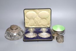 A glass silver mounted inkwell, 2 napkin rings boxed silver dishes and an enamel box