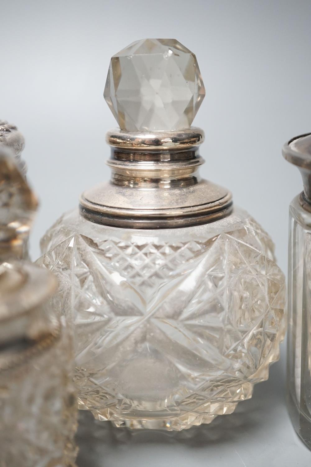 A circular embossed silver box and six silver mounted glass toilet bottles. - Image 6 of 8