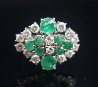 A 20th century 18ct white metal, emerald and diamond set cluster dress ring, size O/P, gross