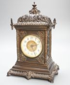 An Edwardian patinated brass mantel clock with key 30cm