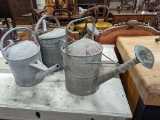 Three vintage galvanized watering cans