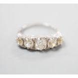 A white metal and graduated five stone old cut diamond set half hoop ring, with diamond chip