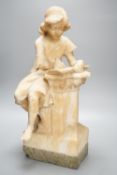 A late 19th century Italian carved alabaster figure of a girl seated, writing at a pillar 47cm