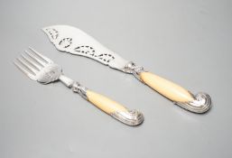 A pair of late Victorian ivory pistol handled silver fish servers, William Hutton & Sons, London,