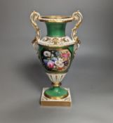 An English porcelain two handled vase painted with flowers in a panel on a green ground, probably