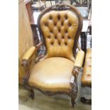 A Victorian carved walnut spoonback open armchair, upholstered in buttoned brown leather, width 69cm