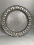 A near pair of Salzburg pewter wrigglework chargers, diameter 41cm, and six similar plates, 18th/