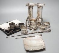 A pair of silver posy vases, a silver mug, a silver dish, five silver napkin rings, two button hooks