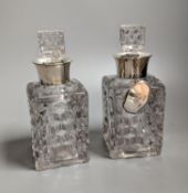 A pair of silver mounted cut glass spirit decanters and a ‘GIN’ spirit label