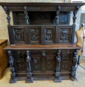 An early 20th century carved oak court cupboard in the Flemish style, length 200cm, depth 58cm,