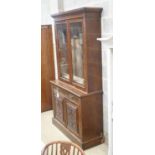 A late Victorian carved walnut bookcase, width 120cm depth 43cm height 220cm