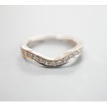 A modern 18ct white gold and diamond set shaped half eternity ring, size H/I, gross weight 3.3