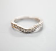 A modern 18ct white gold and diamond set shaped half eternity ring, size H/I, gross weight 3.3