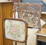 A Victorian rosewood pole screen and a fret cut music stand