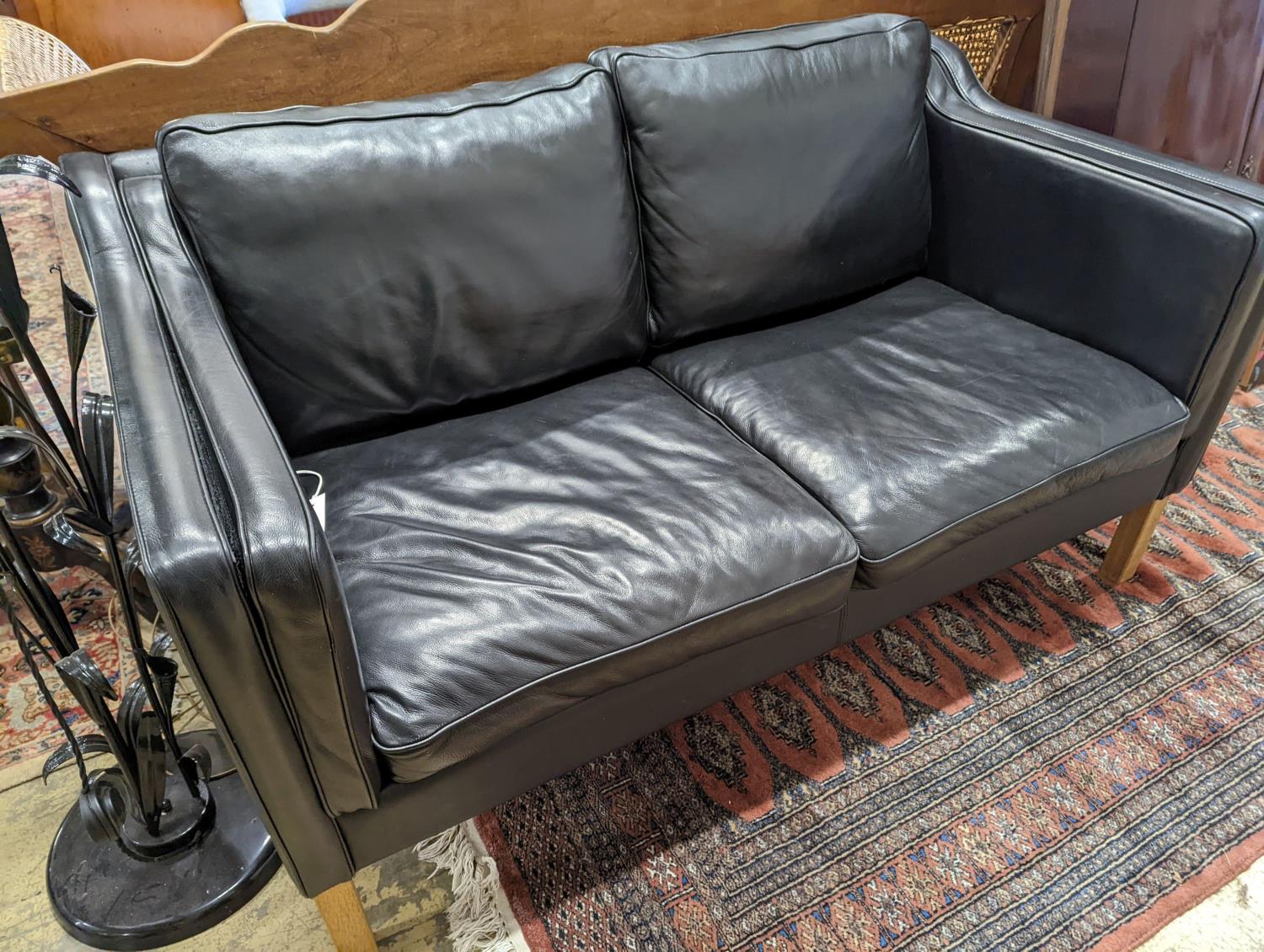 A Danish black leather two seater sofa in style of Borge mogensen
