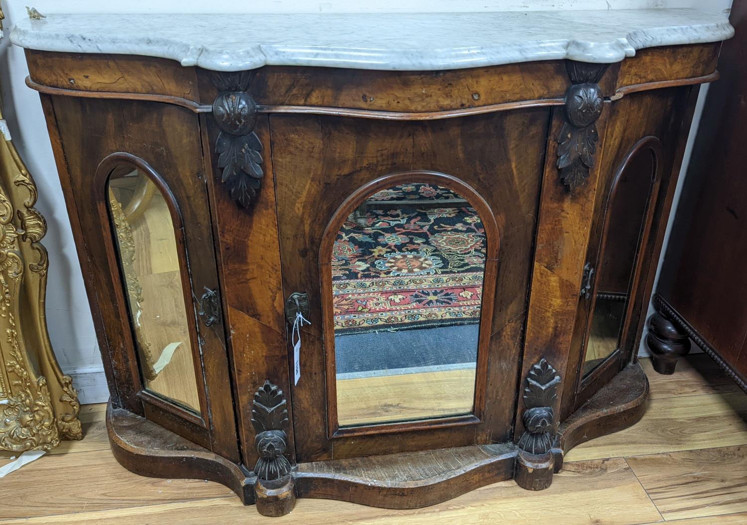 A late Victorian walnut and marble topped serpentine front side cabinet, width 120cm, depth 36cm,