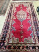 A Hamadan red ground rug, 300 x 150cm