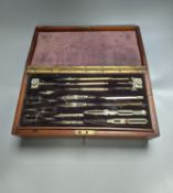 An early 20th century large mahogany case of electrum drawing instruments, wood squares and