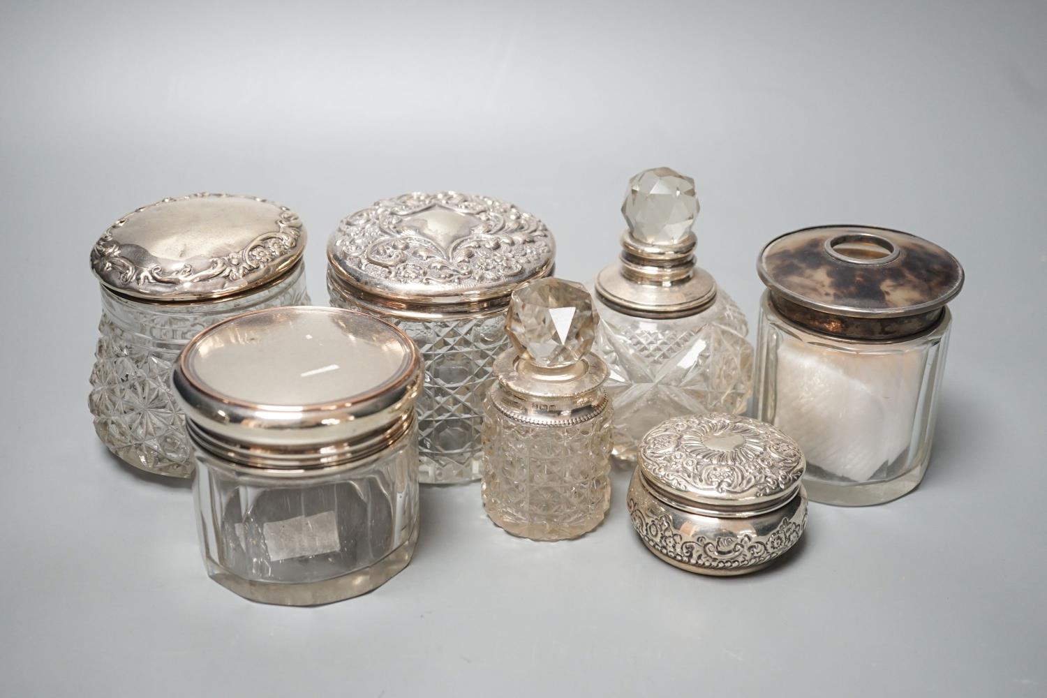 A circular embossed silver box and six silver mounted glass toilet bottles. - Image 2 of 8