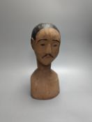 An unusual early 20th century South East Asian carved wood bust, height 30cm