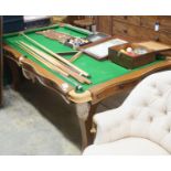 An early 20th century oak snooker / dining table, of rectangular serpentine form, with rise and fall