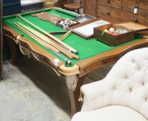 An early 20th century oak snooker / dining table, of rectangular serpentine form, with rise and fall