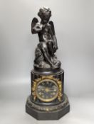 A Late 19th century French bronze and black slate mantel clock, with cherub surmount, drum movement,