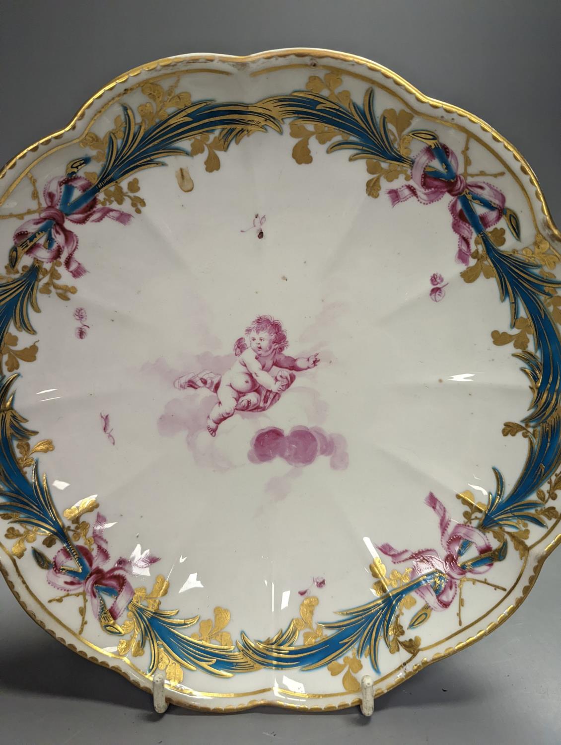 A Chelsea-Derby circular dish painted in puce with a cherub floating on a cloud by Richard Askew, - Image 2 of 3