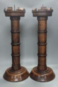 A pair of Pugin inspired Gothic style oak pricket candlesticks, height 56cm