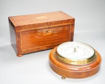 An aneroid barometer in circular polished oak surround and a banded and inlaid two section tea