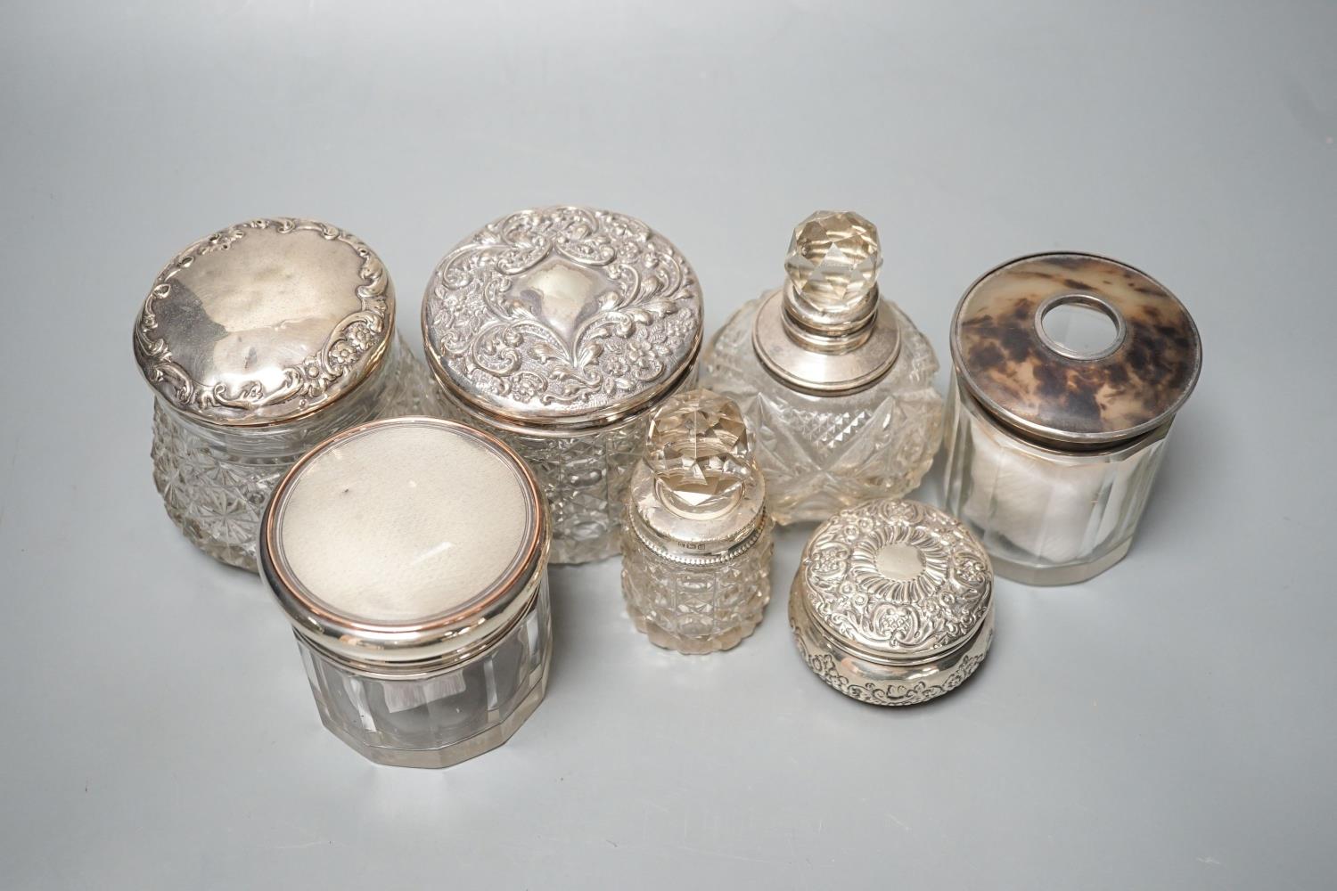 A circular embossed silver box and six silver mounted glass toilet bottles. - Image 3 of 8