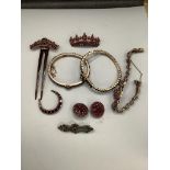 A small group of mixed Victorian gilt white metal and garnet set jewellery, including bangles,