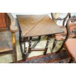 An early 18th century oak drop leaf table, with triangular flap and turned gateleg action