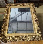 A large 19th century rectangular carved giltwood wall mirror with acanthus scroll frame, width 76cm,