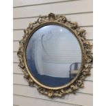 A Florentine giltwood convex mirror, diameter 70cm