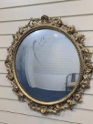 A Florentine giltwood convex mirror, diameter 70cm
