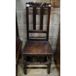 A late 17th century oak back stool, with carved cresting rail, slatted back and solid seat, on