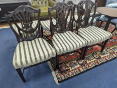 A set of six Sheraton style mahogany dining chairs with shield backs on square tapered legs