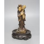 A 19th century Chinese soapstone figure of He Xiangu, associated wood stand 19cm