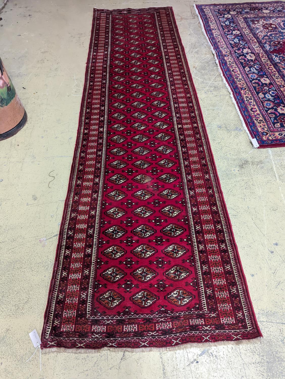 A Bokhara red ground runner, 364 x 98cm